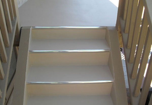Stairs treated with waterproof walkway coatings to make slip resistant