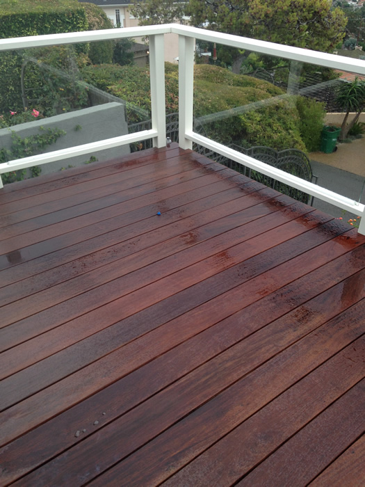 Orange County deck waterproofing company installs clear glass railings to improve the view