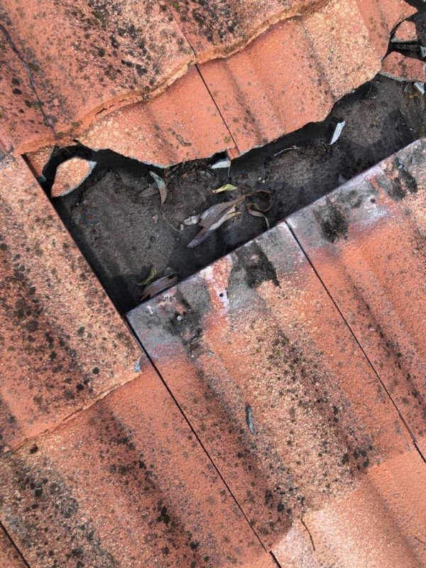 Close-up of tile roof repair work at the flashing
