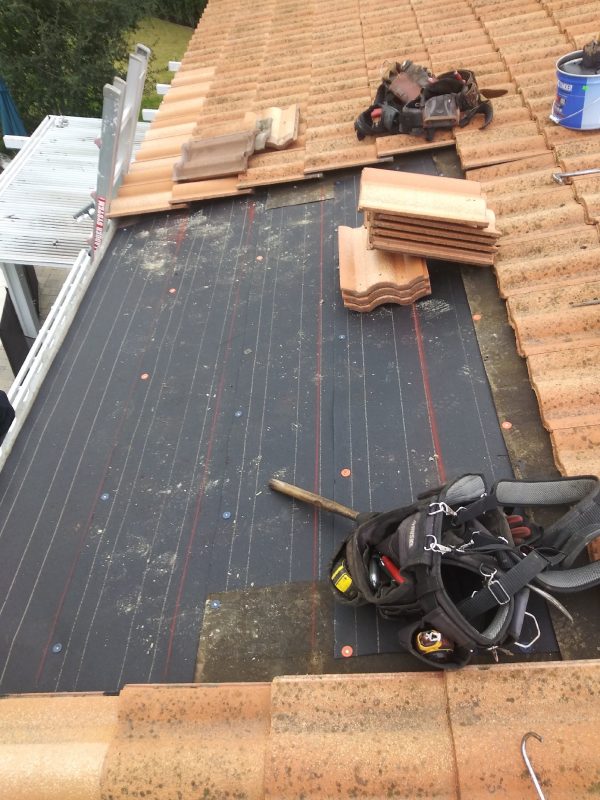 Tile roof repair with underlayment replacement