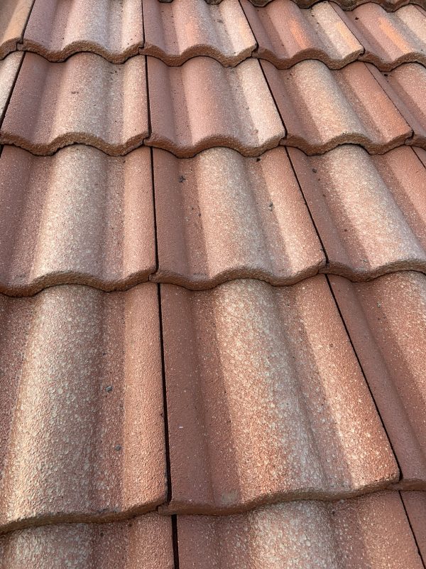 Clay tile roof after repair, tiles reset in line
