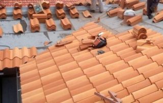 New tiles and exposed synthetic underlayments during tile roof repairs