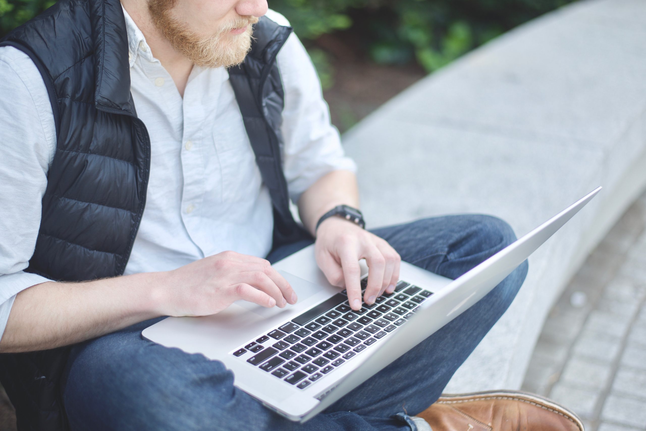 man on laptop checking references of California deck contractor online