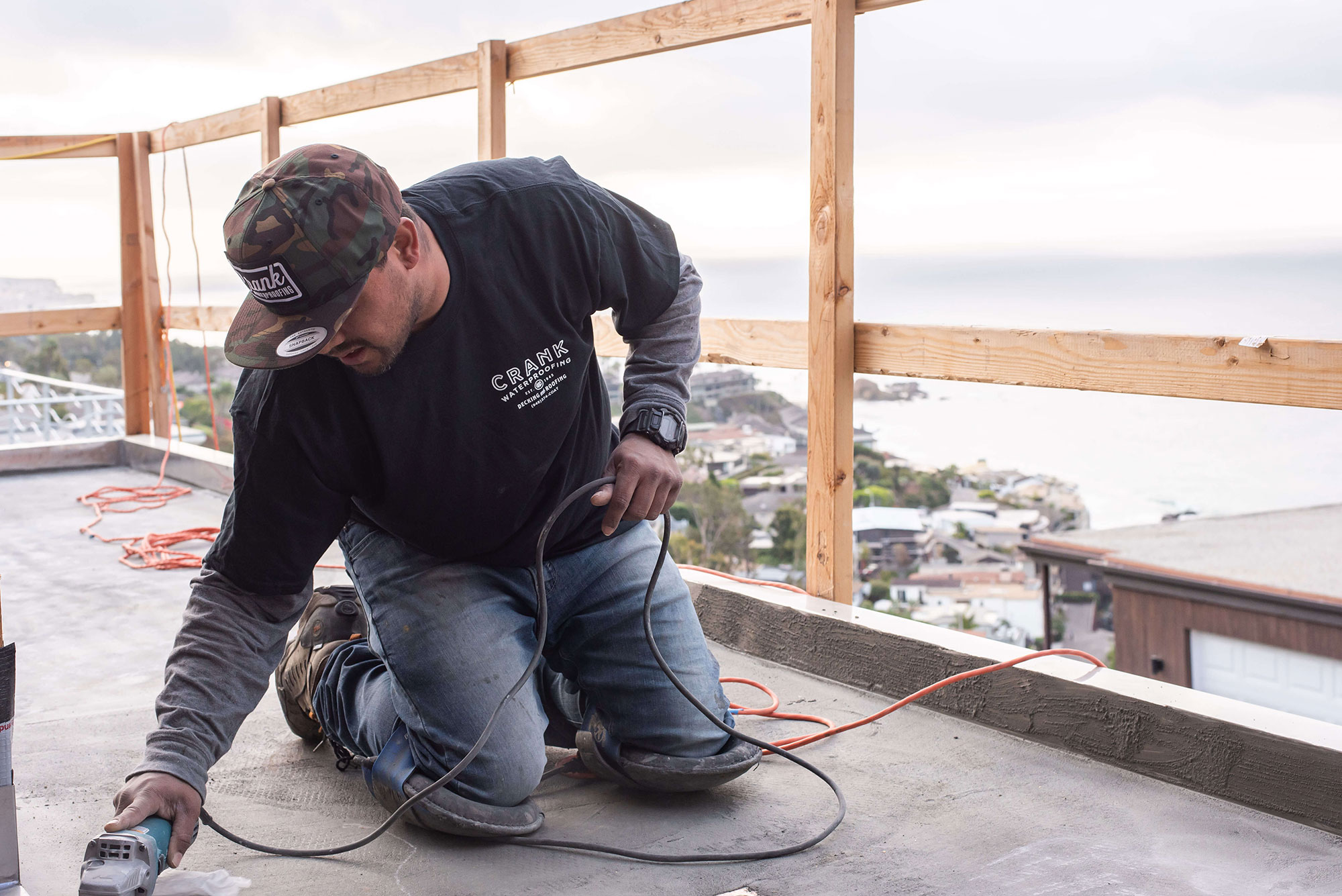 Orange County deck contractor on his knees with nail gun building a new deck