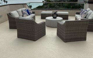 beige deck waterproofing with knockdown texture as a floor with brown patio furniture on deck by the ocean