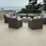 beige deck waterproofing with knockdown texture as a floor with brown patio furniture on deck by the ocean