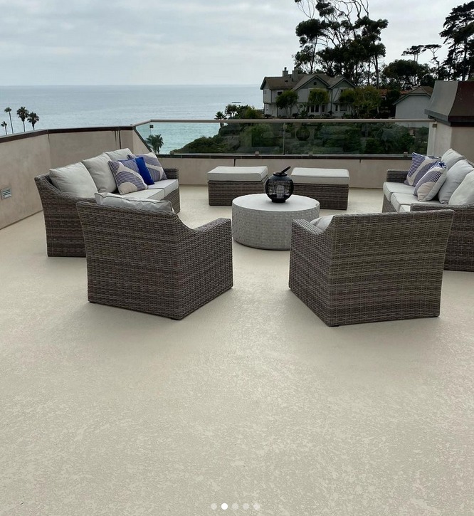 beige deck waterproofing with knockdown texture as a floor with brown patio furniture on deck by the ocean