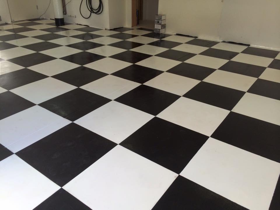 black and white checkerboard epoxy garage floor coating looks like a flag