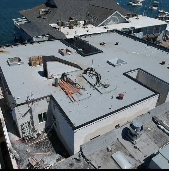 arial view of Newport Beach commercial building flat roof repairs and roof coatings application taken from drone