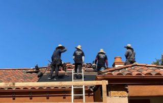 Men standing on roof during Orange County roof repair job