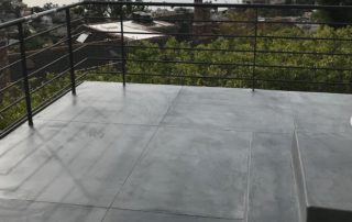 waterproof deck coatings used to simulate the look of concrete on deck overlooking the ocean