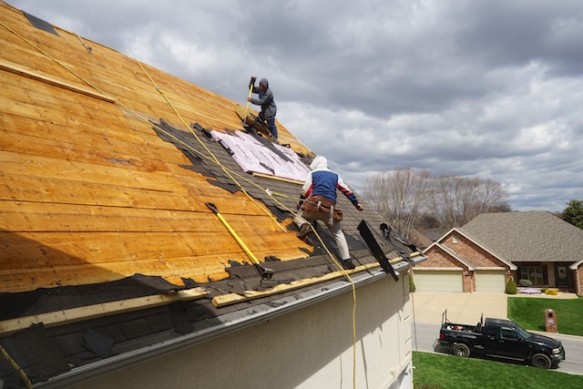 men completing roof repair in orange county