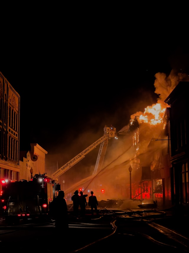 fire truck and tall building on fire at night