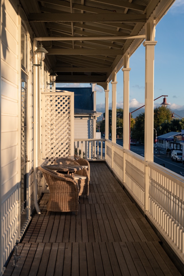 small balcony with white deck railings overlooking the beach